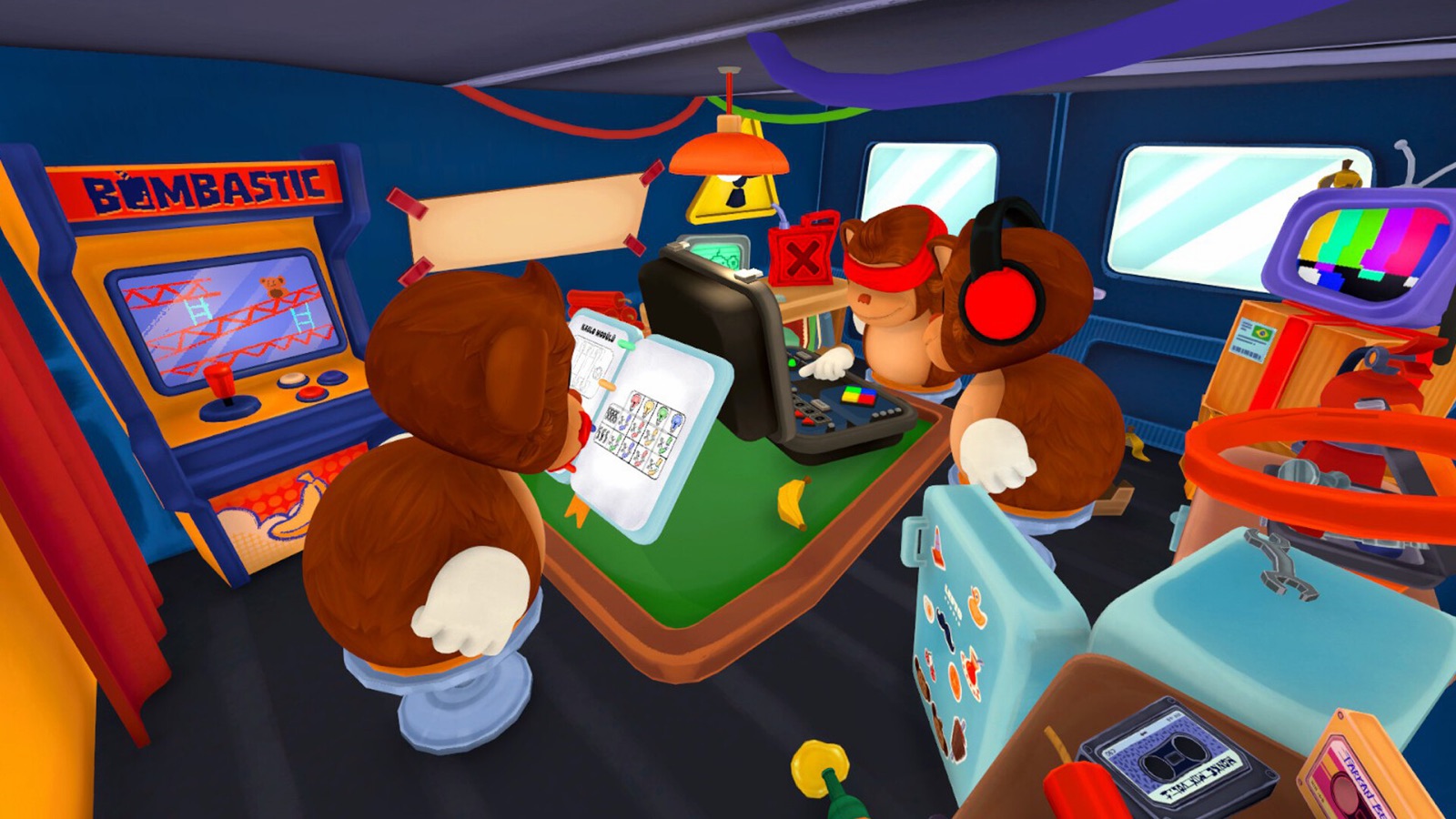 Three BOMBANANA monkeys gathered around the bomb case: the Mute Monkey holding the open manual, the Deaf Monkey with red ear muffs, and the Blind Monkey with a red blindfold in the foreground